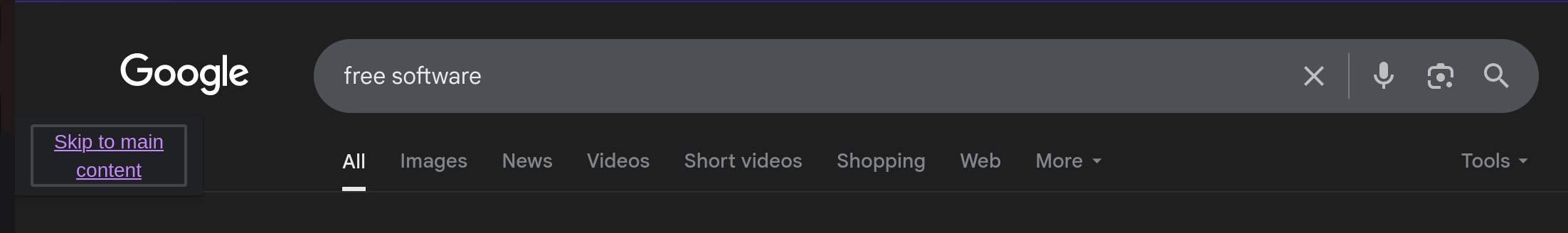 An example of a google search for "free software" where the first selectable element by keyboard navigation is "skip to main content"